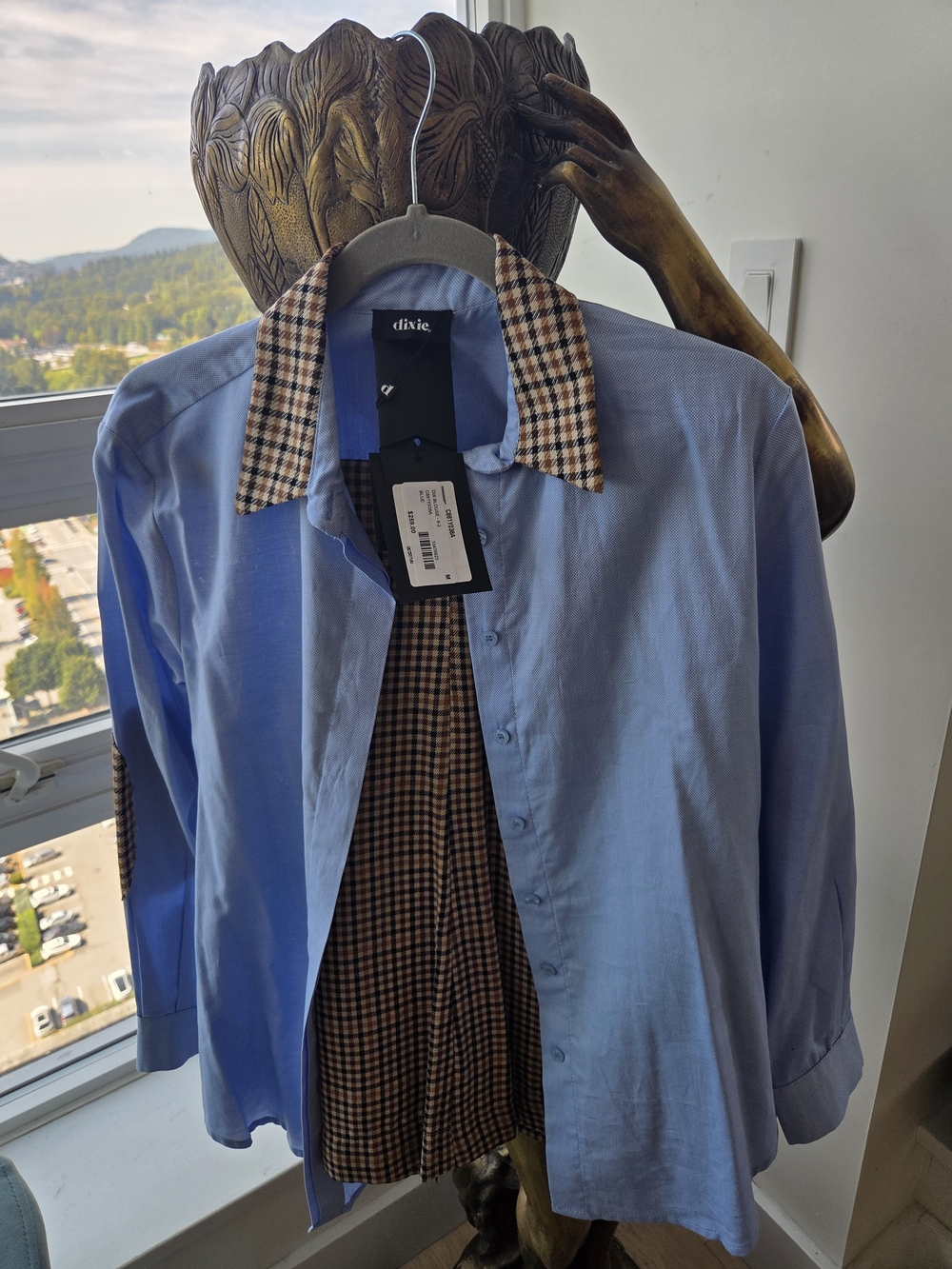 Woman’s Light Blue Button-Up Shirt with Checked Collar And Matching Pants.